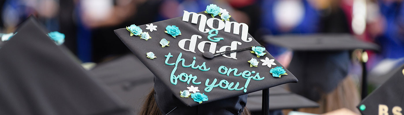 Graduation cap that reads "Mom and Dad, this one is for you"