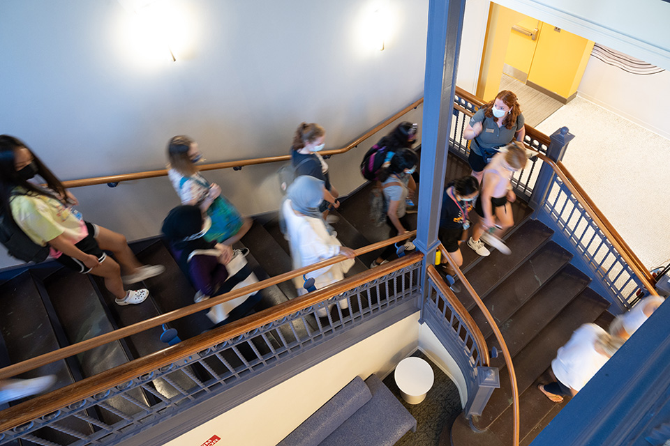 Group tour during orientation 2022 in MCB heading down main staircase