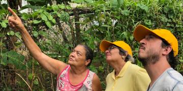Carmen Báez and Andre de Haro (PRxPR) inspecting damage housing with resident of Villa Calma community  in Toa Baja, PR - July 2019