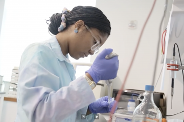 A student doing an experiment using a pipette in the science lab