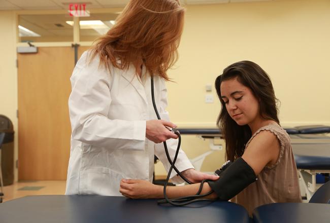 Nurse taking a students blood pressure