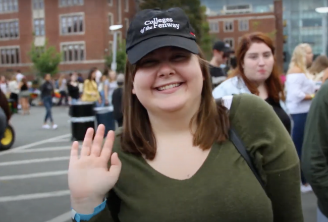 A student wearing a Colleges of the Fenway hat
