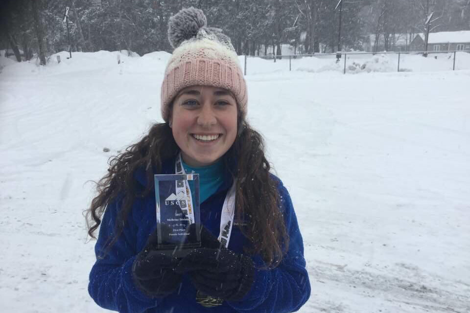 Lindsey Sumpman holding award