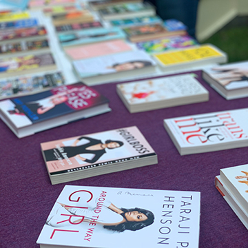 A table full of books from an All She Wrote Books pop-up event.