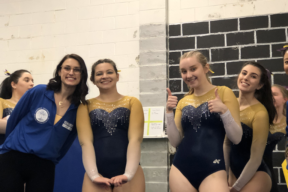 Cori Szabados with gymnastics teammates