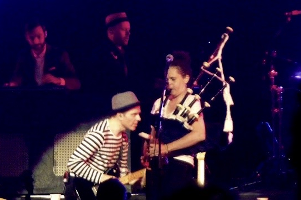 Abbye Meyer playing bagpipes at a concert.