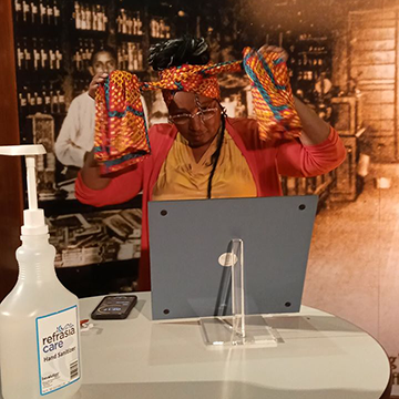 Women wrapping a headscarf during the Juneteenth Celebration