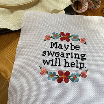 Cross Stitch by Renada Goldberg. Flowers with the quote "Maybe swearing will help."