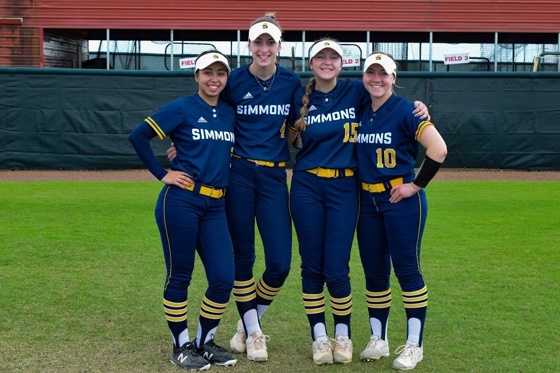 Kylie Collins with members of the Simmons Softball team