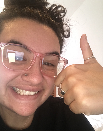 Headshot of Maude Elovitz giving a thumbs up