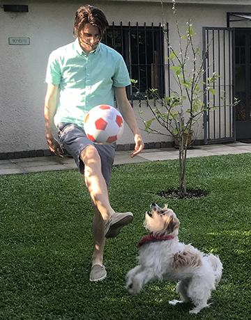 Aaron Rosenthal playing soccer with his dog, Sonny