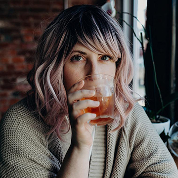 Kaitlyn Soligan Owens taking a sip of a drink.