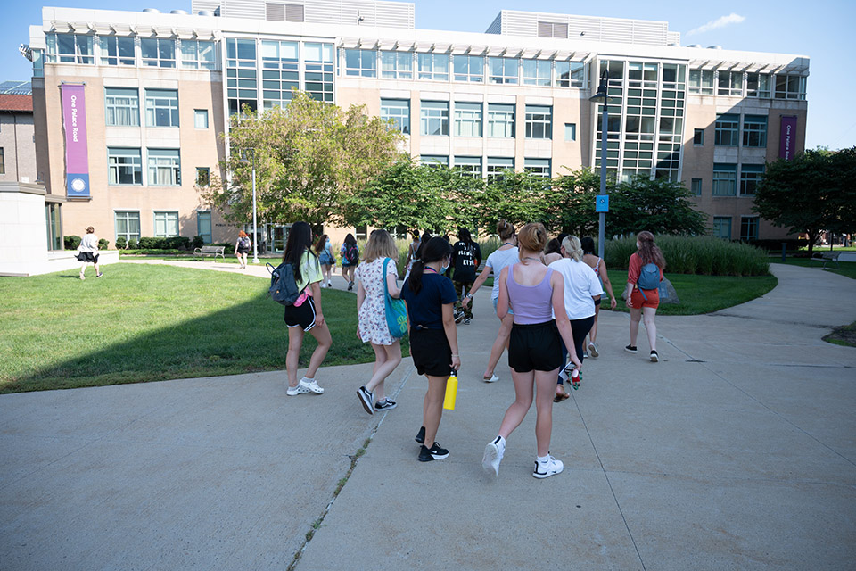 Group tour during orientation 2022 in main quad heading towards Palace Road Building