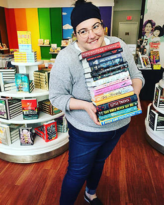 Christina Pascucci-Ciampa holding a stack of great books