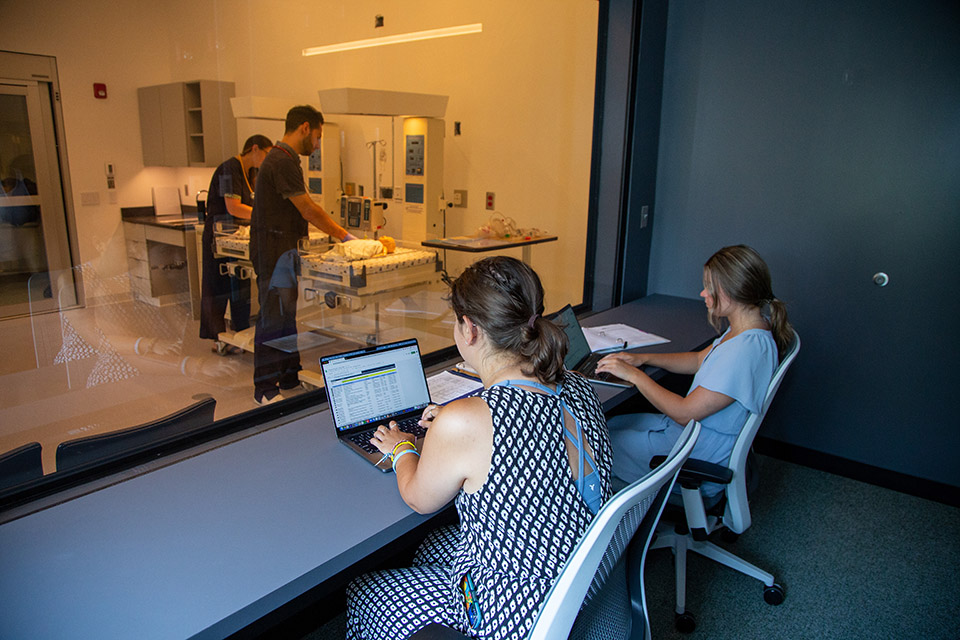 Two Students observing work in Science Center nursery