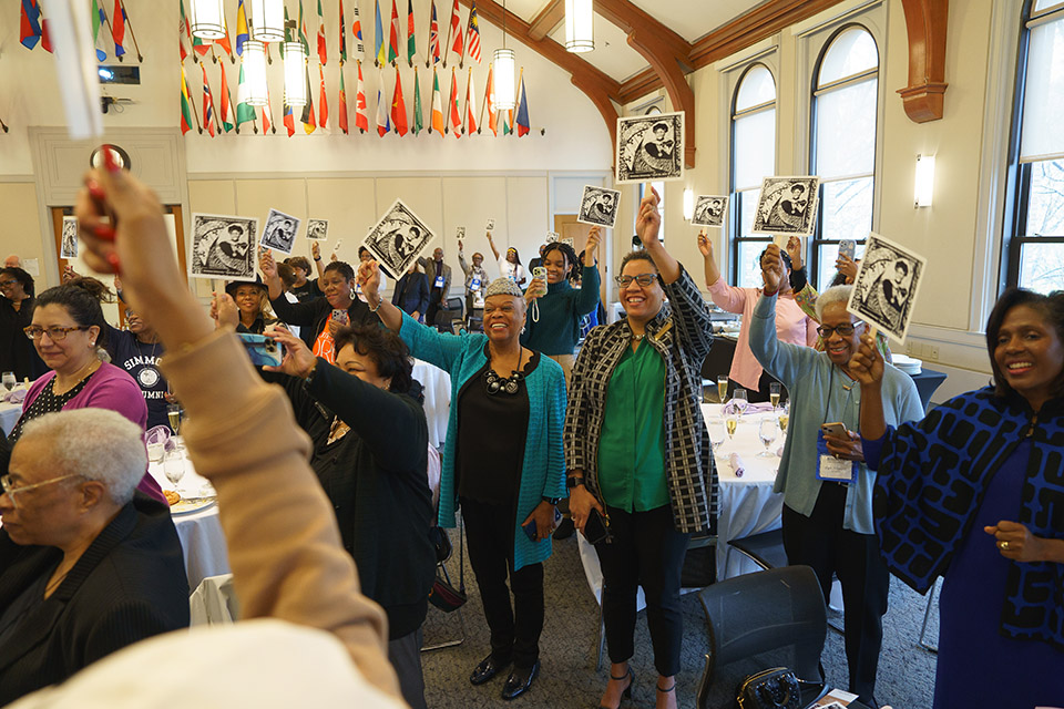 Group of Alum and President Wooten holding signs at Black Alumnae/i Symposium 2023