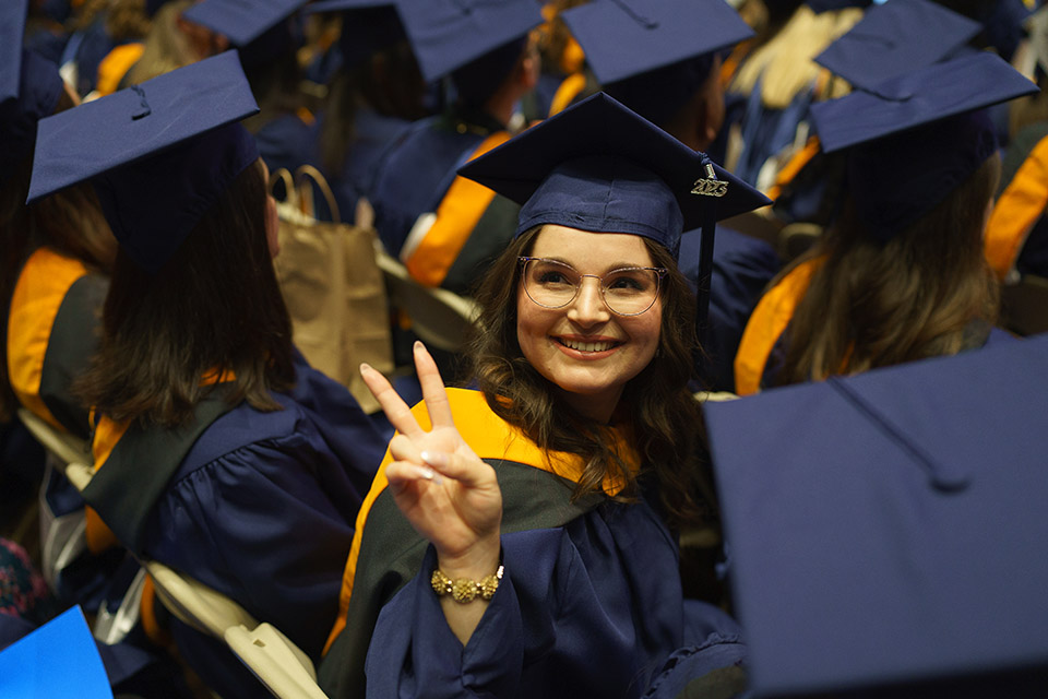 Graduate Student giving peace sign