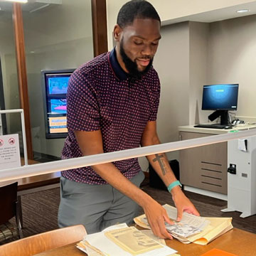 Archivist Derek Mosley organizing papers at work