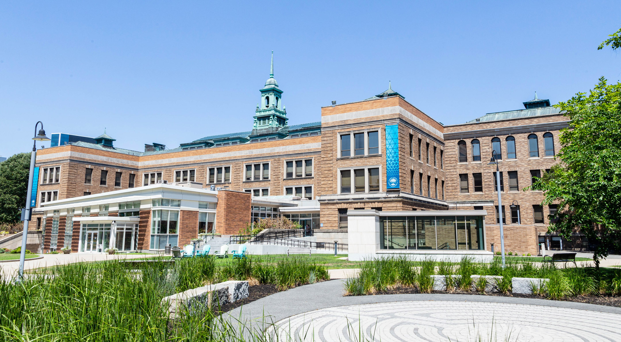 Main Campus Building exterior within the campus quad on a bright, sunny day
