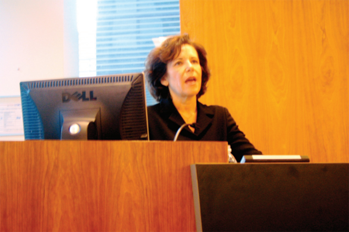 Denise Di Novi standing at a podium