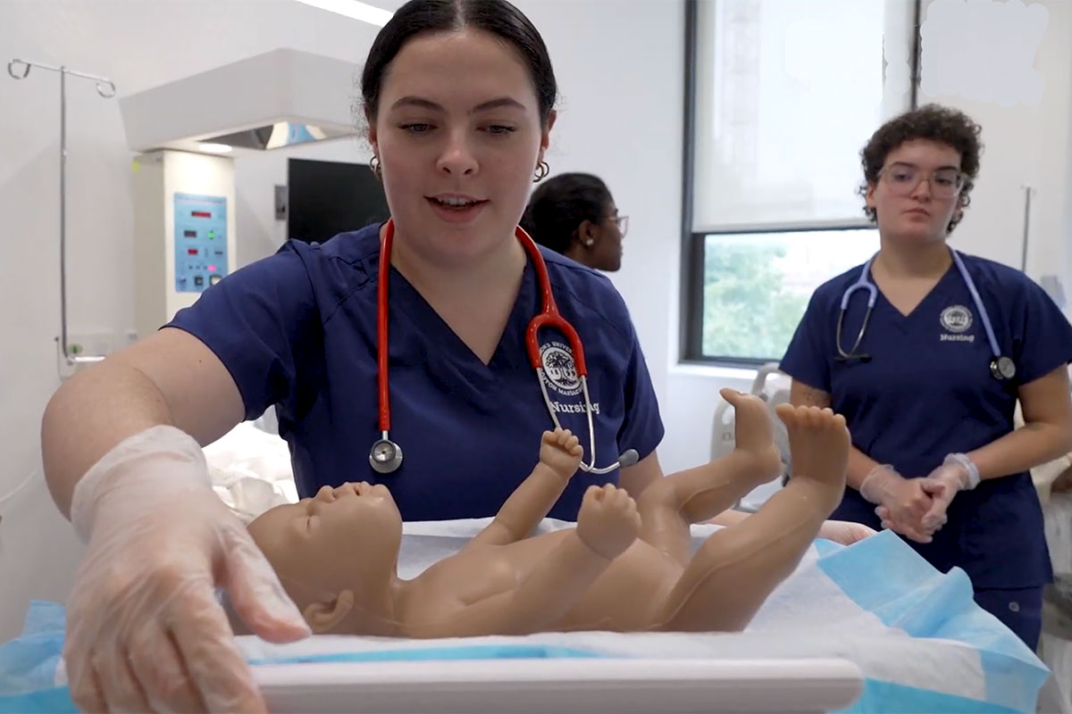 Simmons nursing students working in the pediatric section of the simulation lab