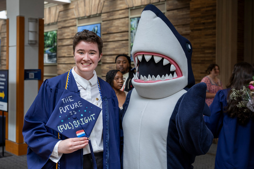 A graduating student poses with Stormy