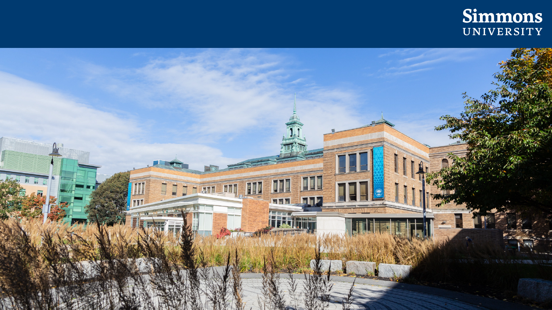 A Zoom background displaying the Simmons logo in a dark blue bar across the top of a photo of the Main College Building