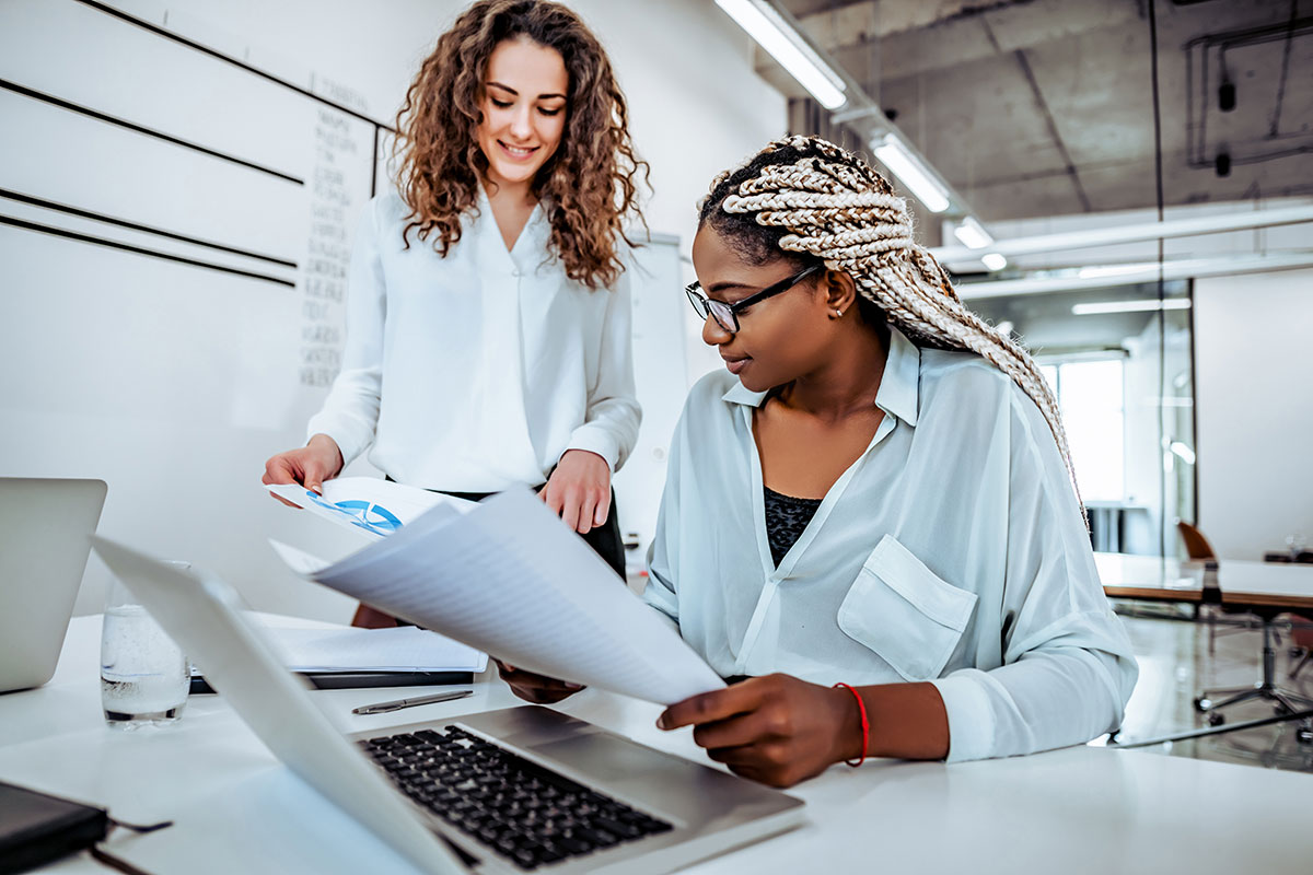 Two women working on a project at a desk