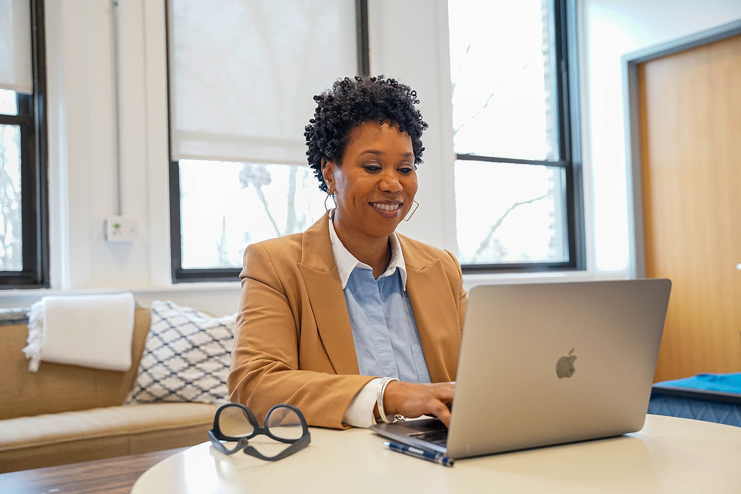 Student working on laptop in office space