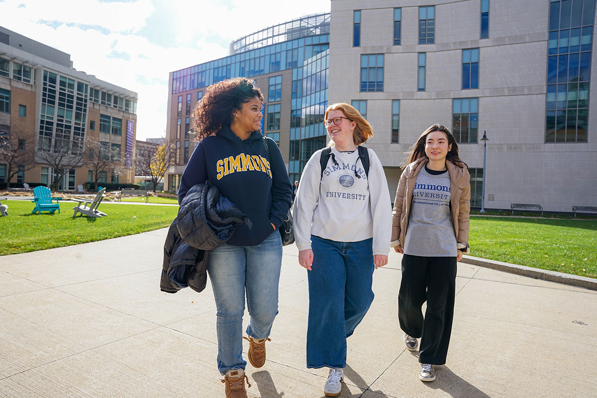 Three undergraduate students walking on the campus of Simmons University