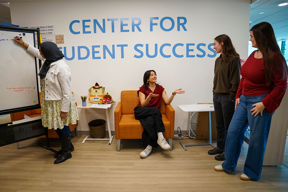 Students working together near the sign for the Center for Student Success