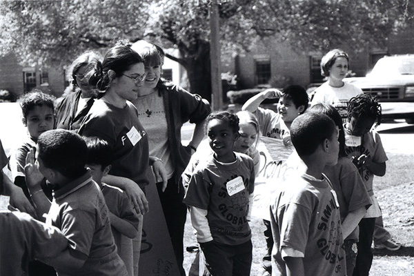 Simmons students working with children outside