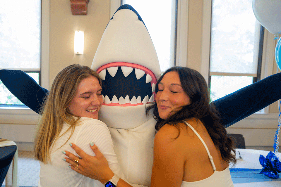Stormy, the Simmons University mascot, welcomes new students.