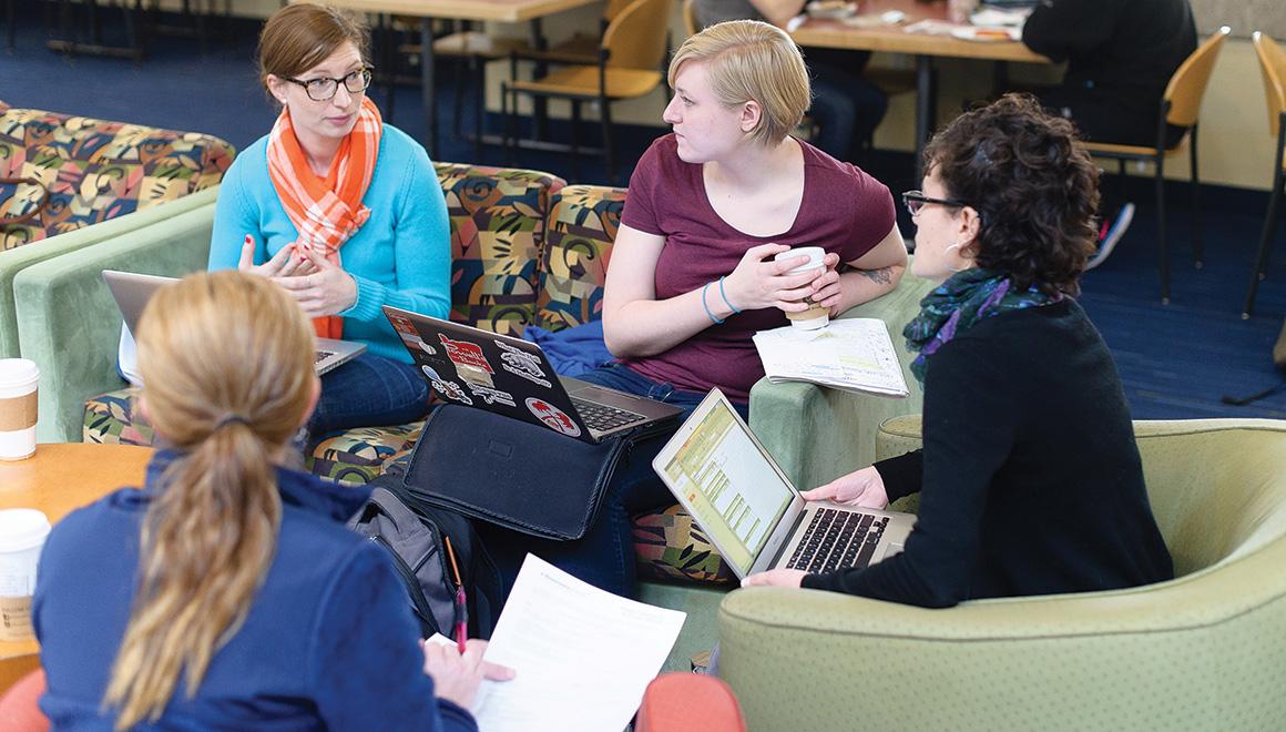 Students sitting in the common area of the Main College Building