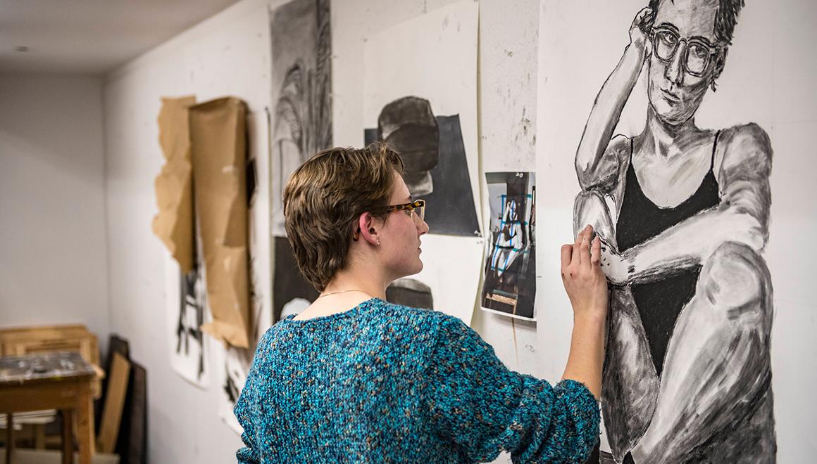 Student working on a self portrait in art class