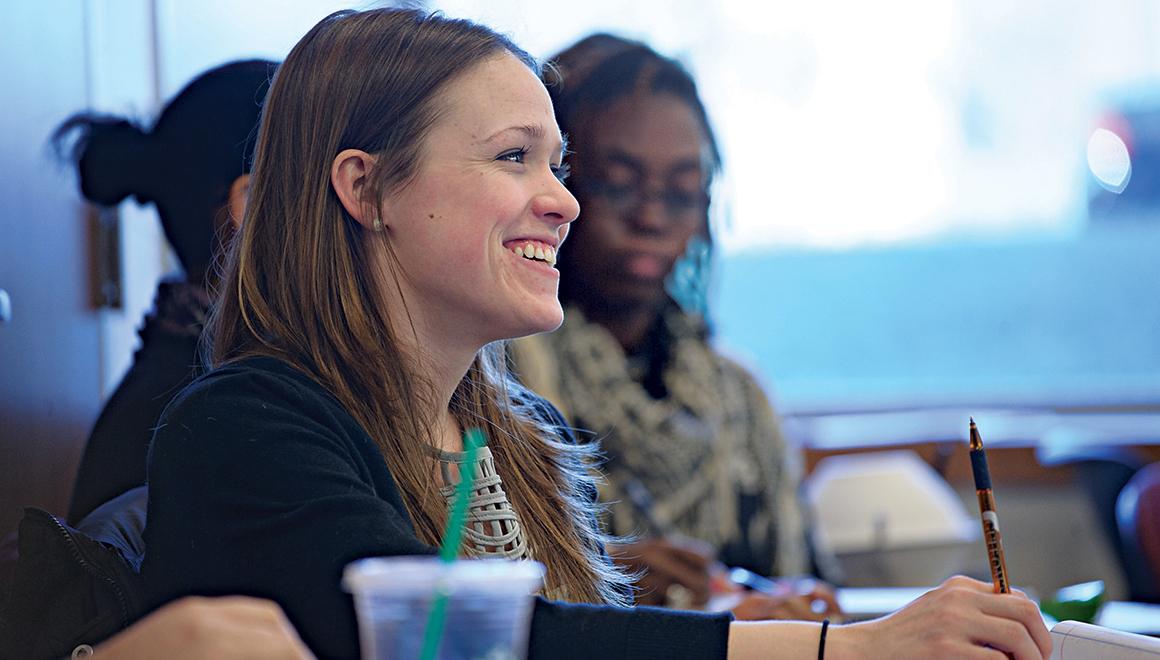 Students sitting in class smiling