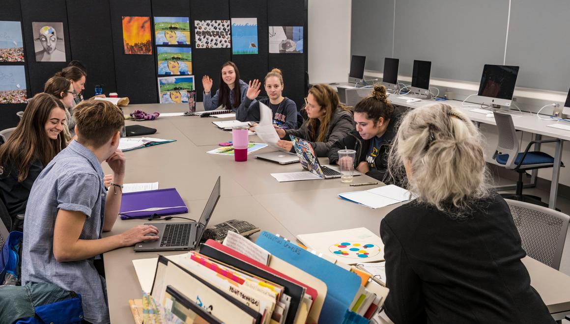 Students looking at art in an art class