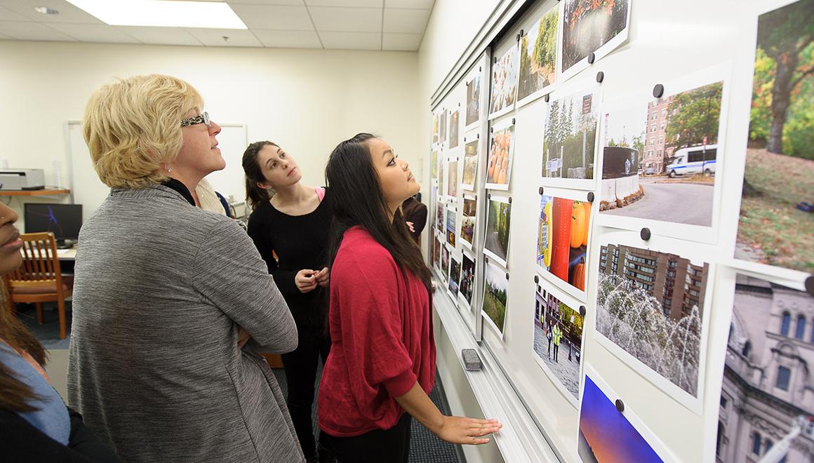 Students looking at photographs in class