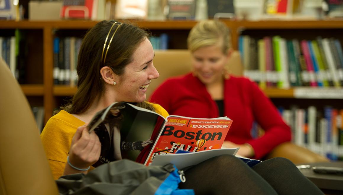 Student reading a magazine in the library