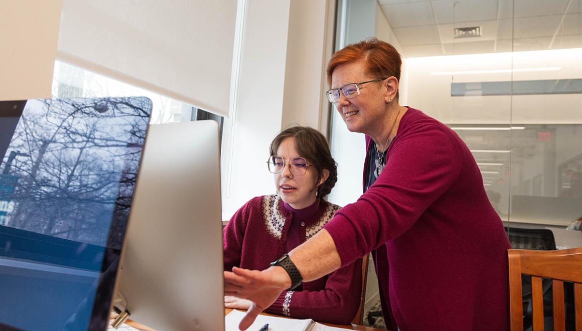A Library and Information Science faculty member working with a student