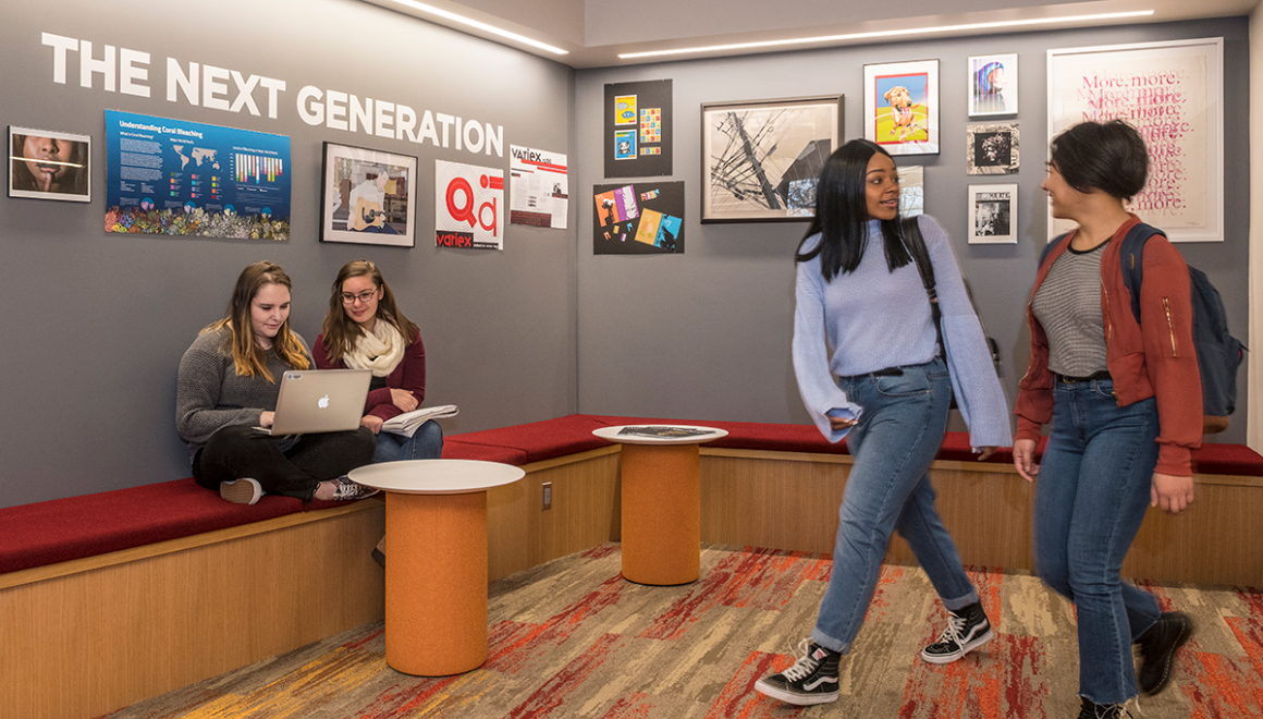 Simmons students working in and walking through the Ifill School lobby