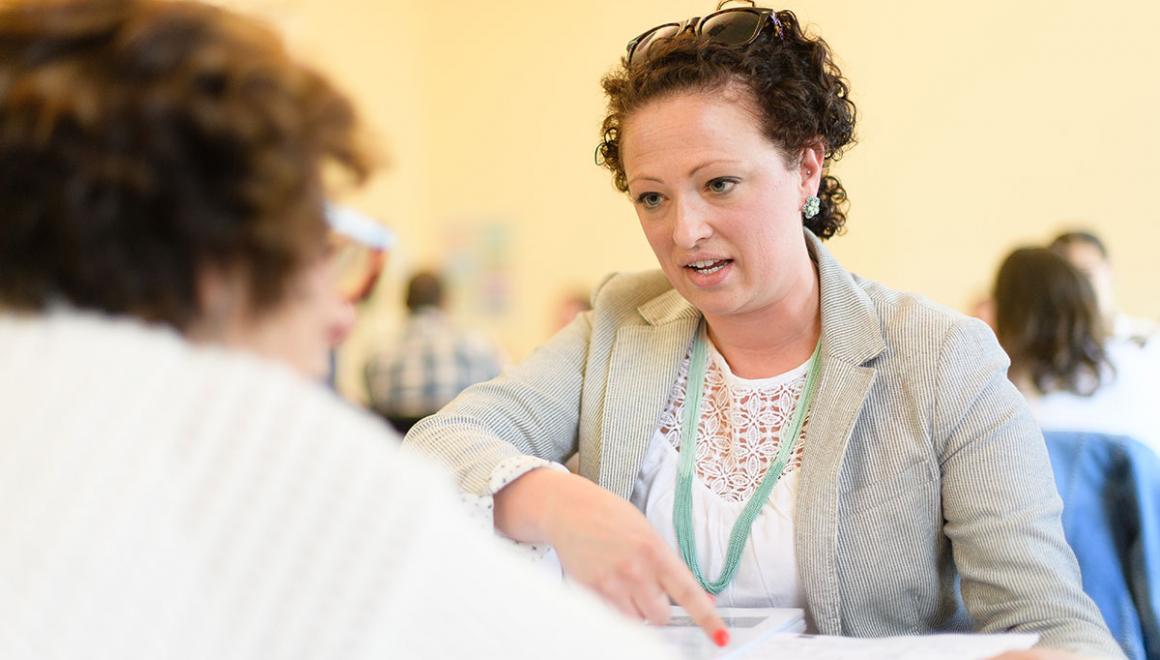 Two adult Simmons students having a conversation during a class