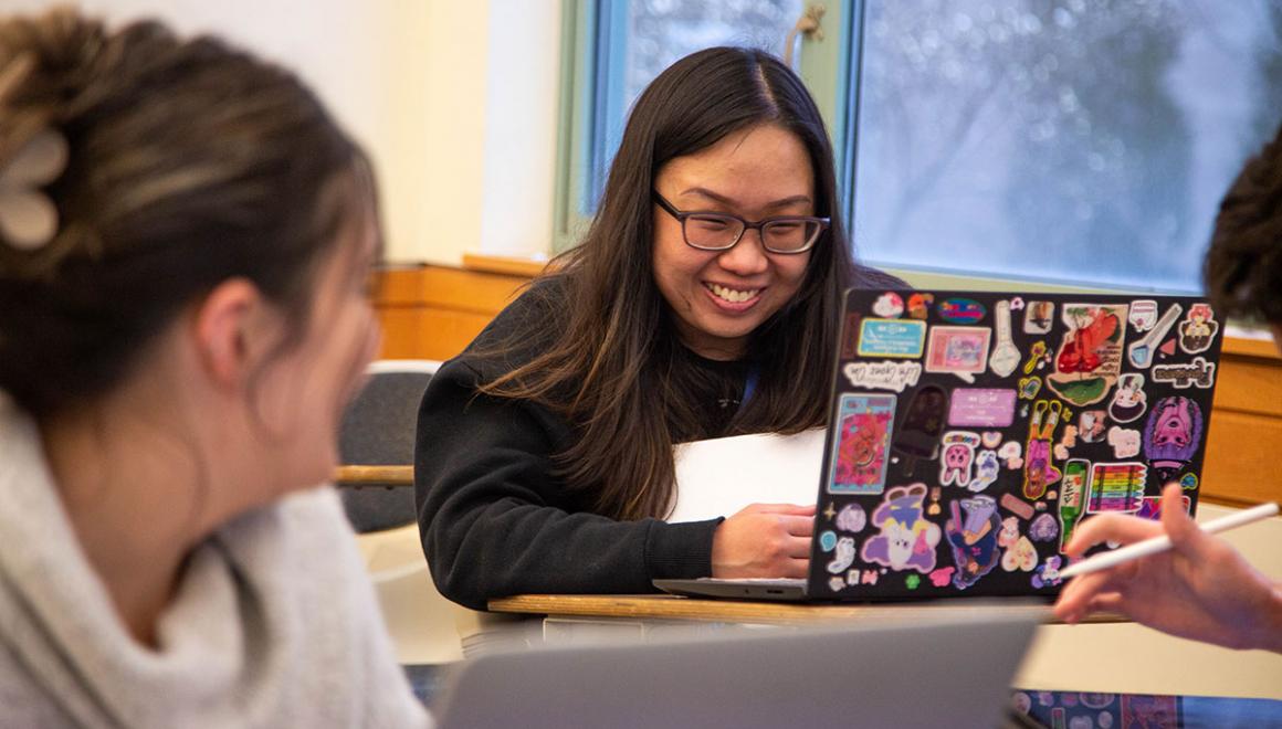Simmons students in a classroom with laptops on their desks