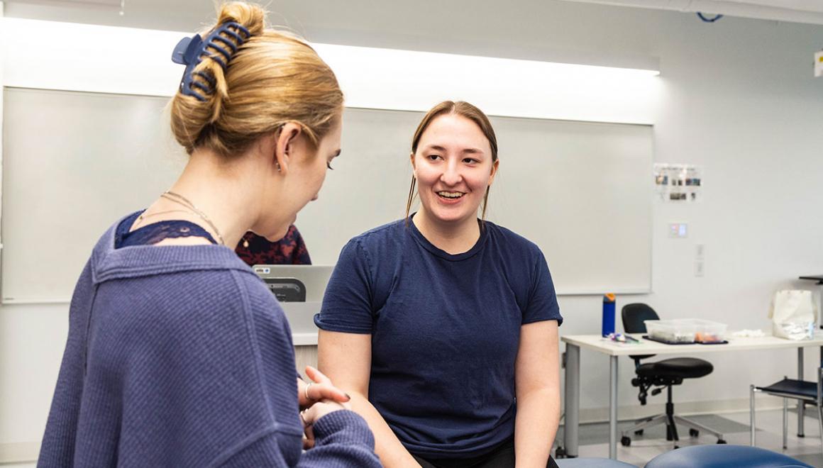 Two Simmons students doing a simulated visit in the health sciences lab