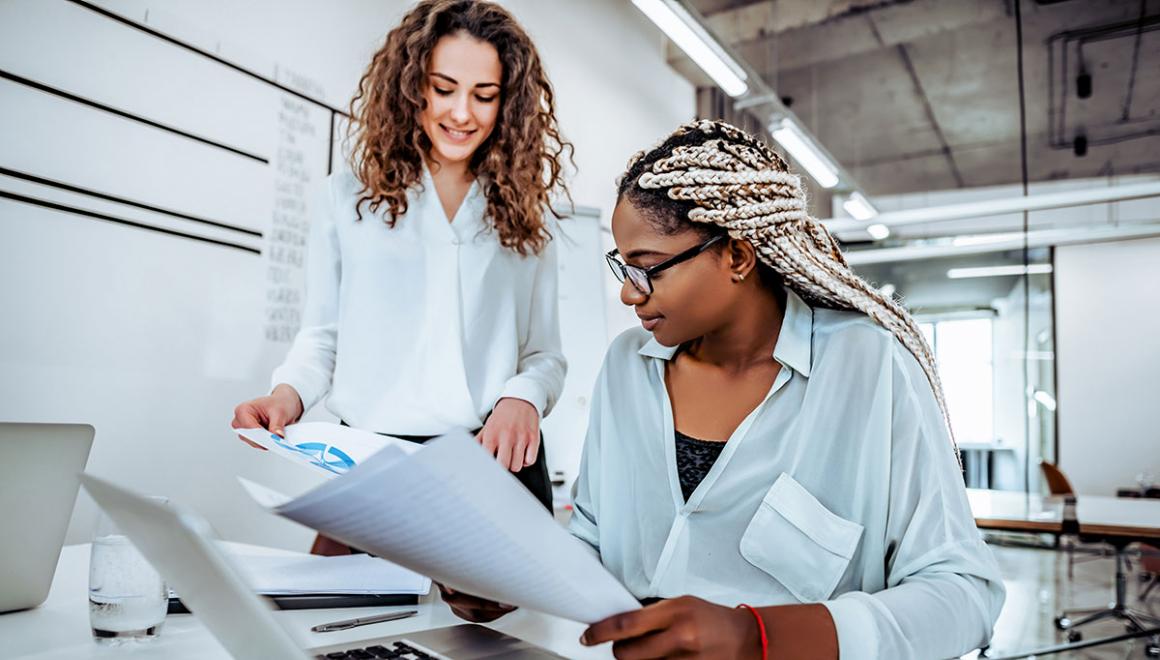 Two women working on a project at a desk