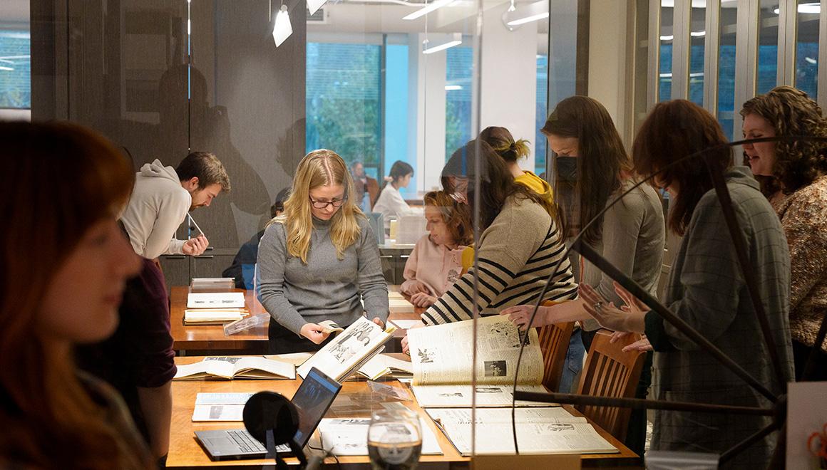 SLIS students looking through archives together in library