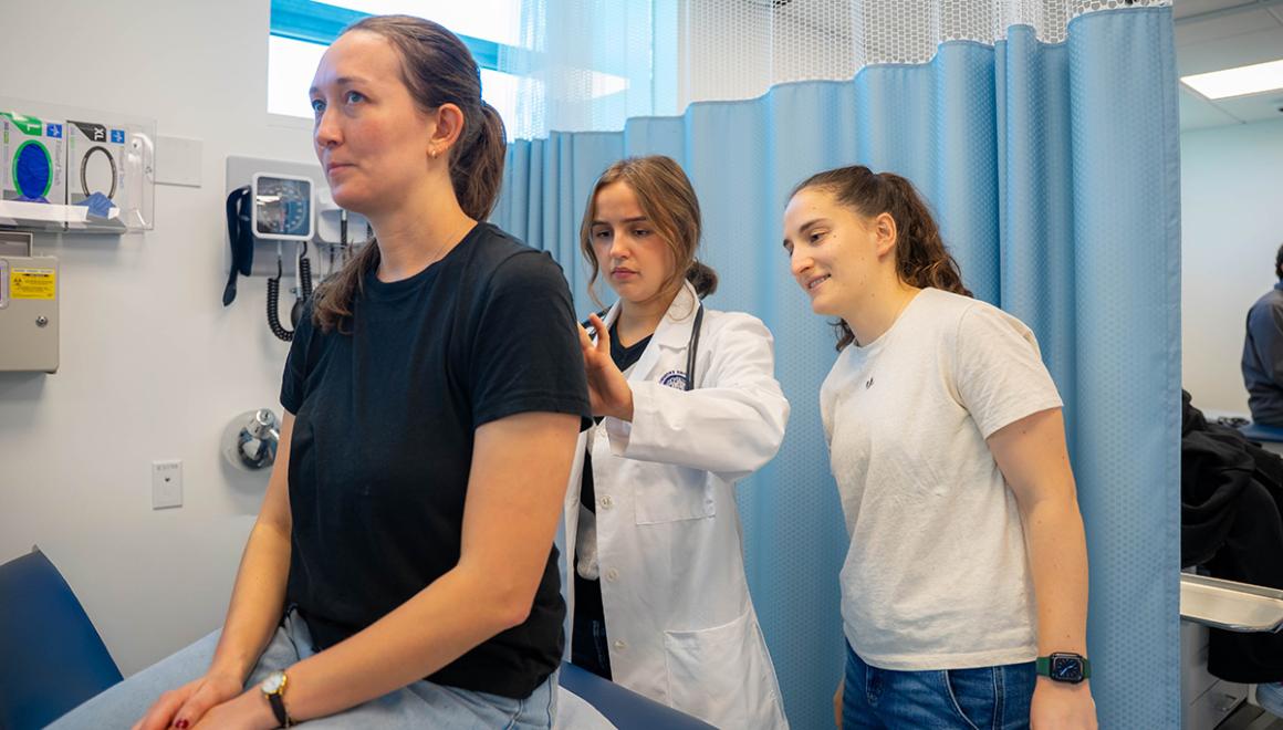 Simmons nursing students doing hands-on practice in the nursing lab