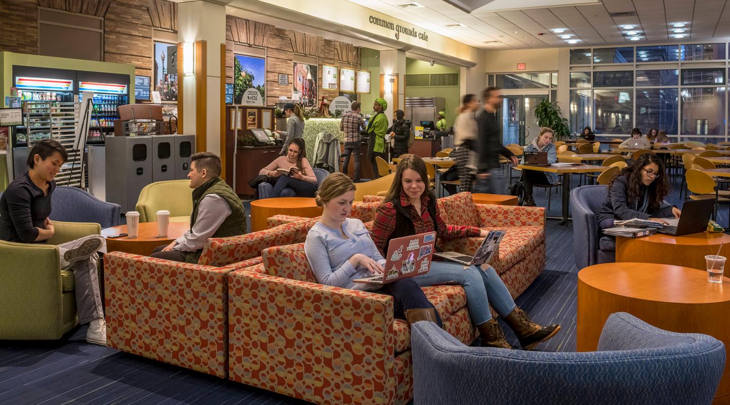 Students sitting in a common area in the Main College Building at Simmons University