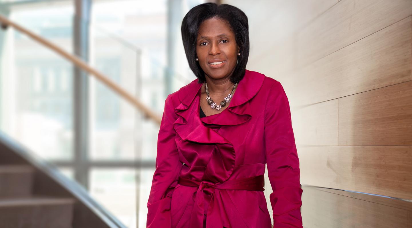 President Lynn Perry Wooten standing on stairs.