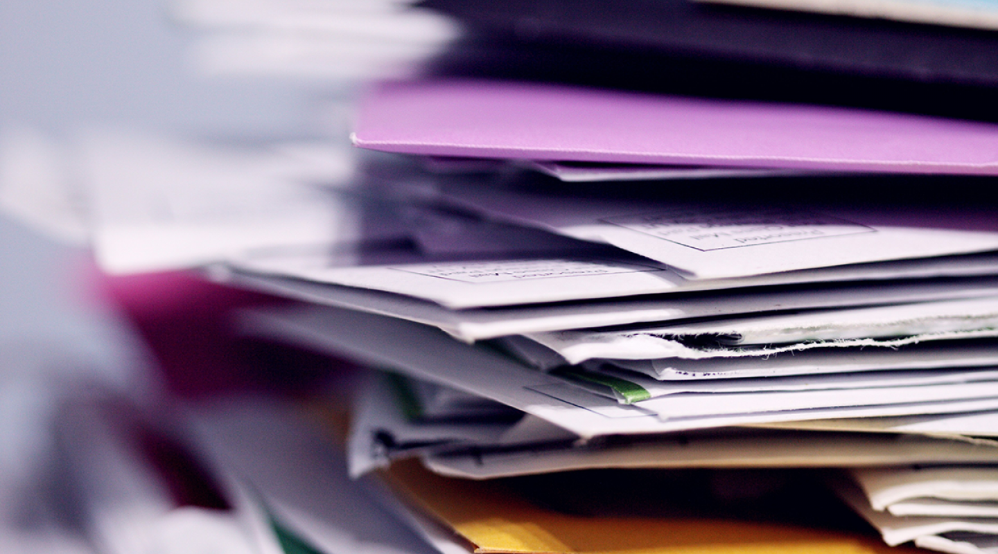 A pile of mail including a variety of envelopes